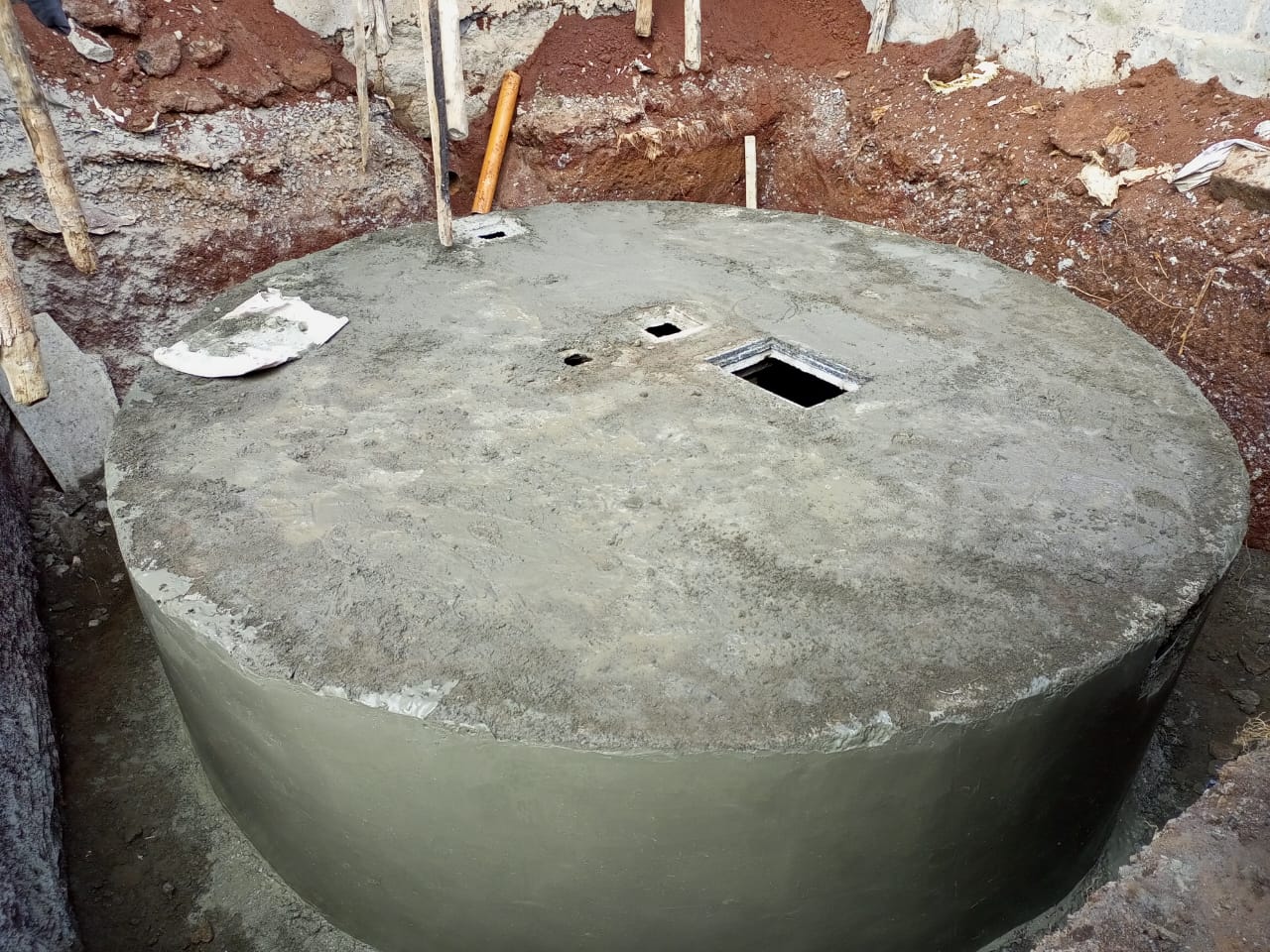 Aquamet field team installing a concrete biodigester on site