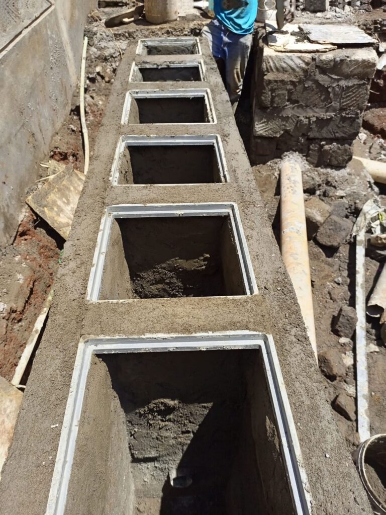 Grease interceptor installed beside a kitchen